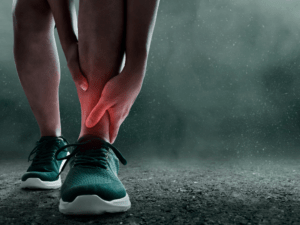 Sportowiec trzymający kostkę z widoczną oznaką bólu